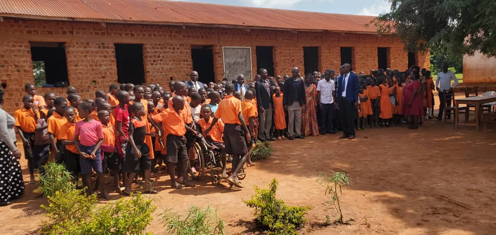 The Chief Administrative Officer - Kamuli, with pupils of Nabulezi COU Primary School after an assessment of existing structures